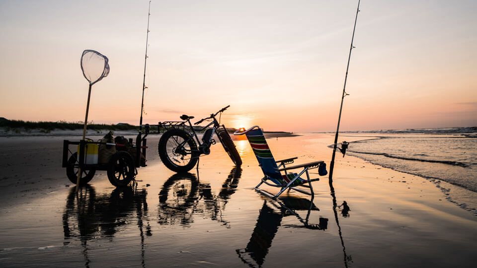 Sunset at the beach with Rambo electric bike and trailer with fishing poles